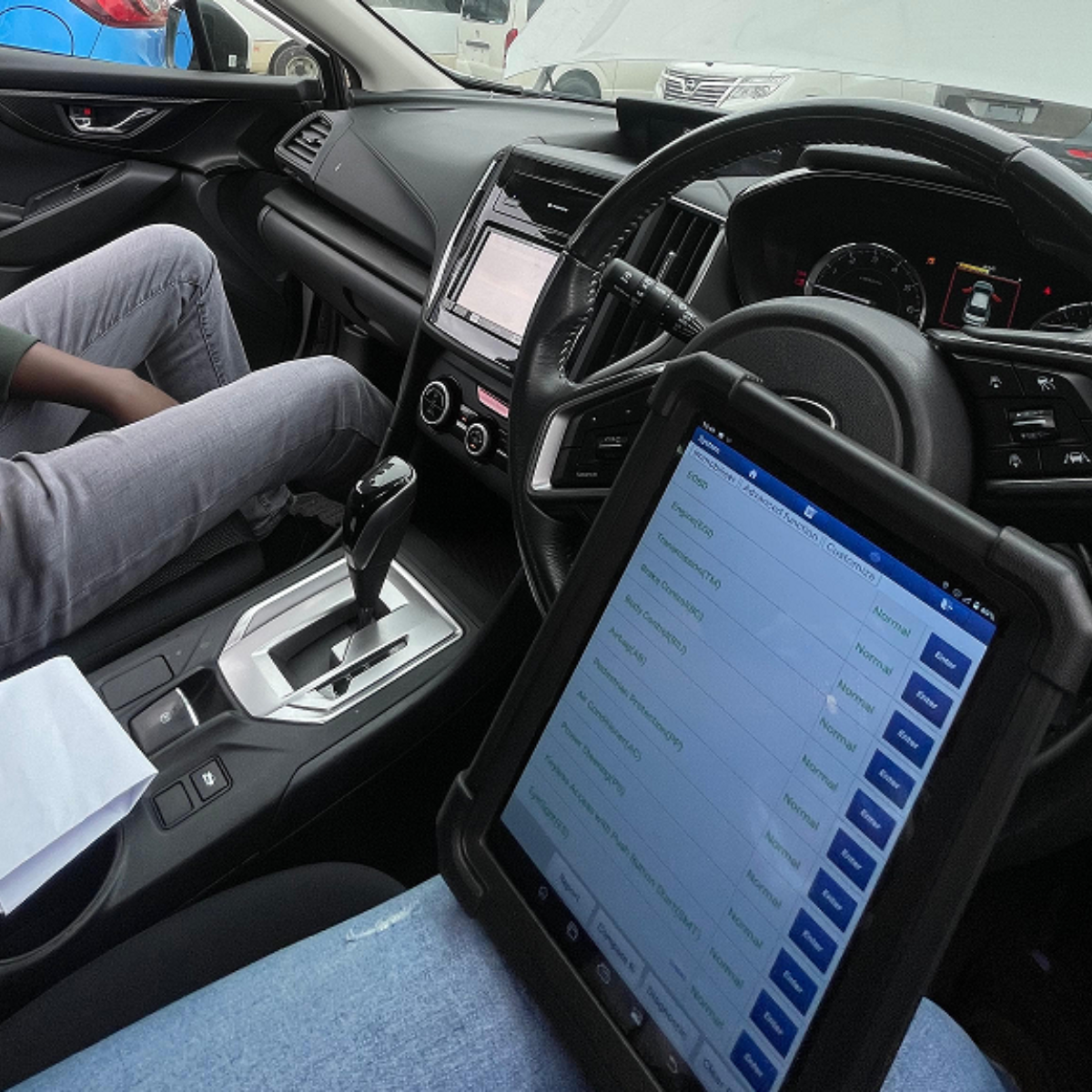 Maztech specialists working on a Mazda
