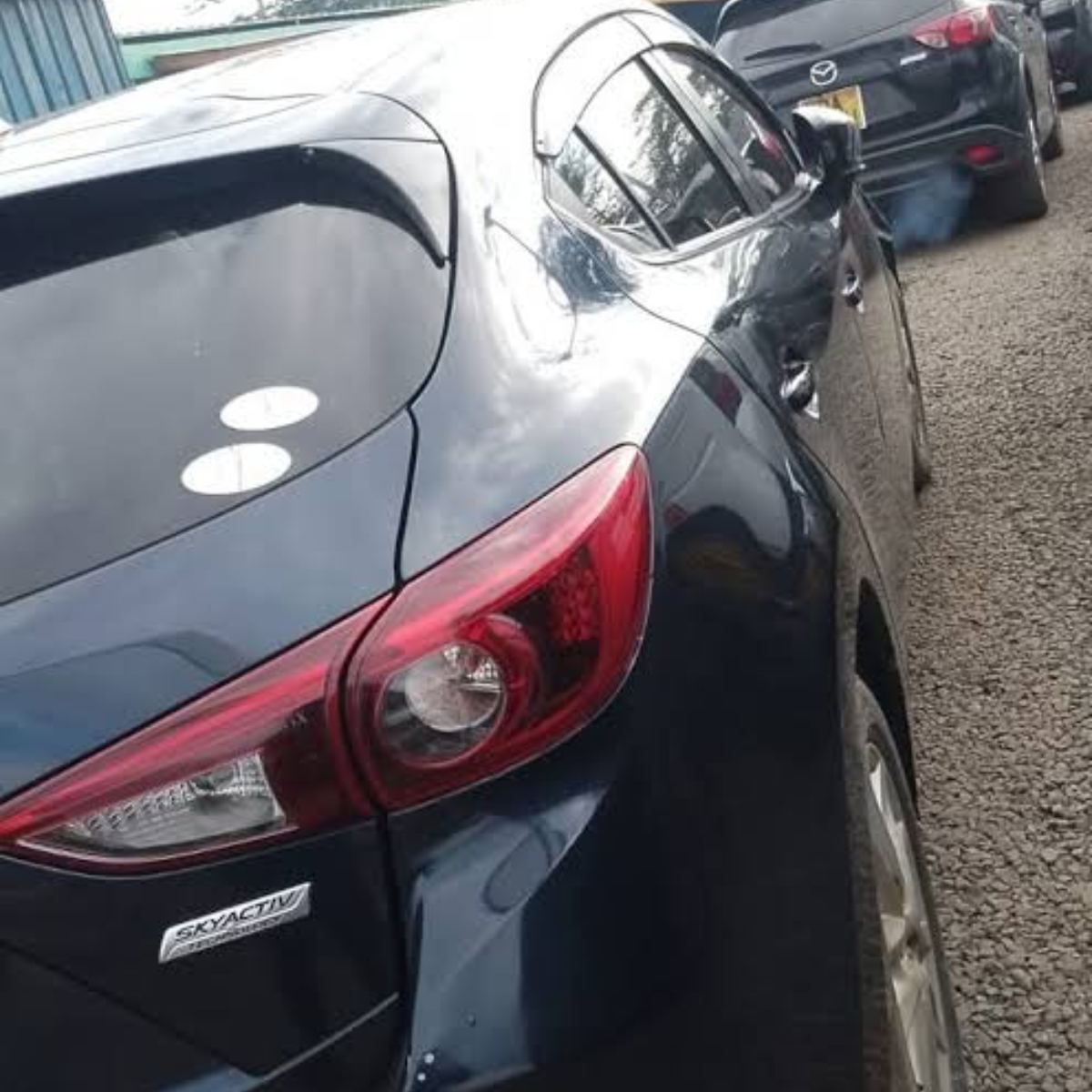 Maztech technician with serviced Mazda